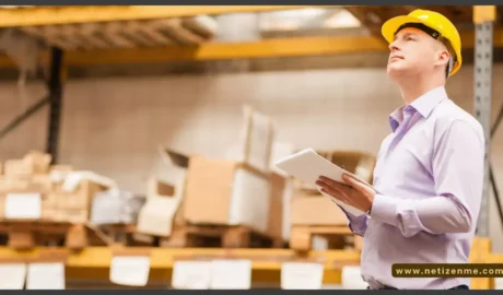 An engineer standing with a white paper in his hand and light brown background - Why Consider Just-in-time Inventory and Vendor-Managed Inventories